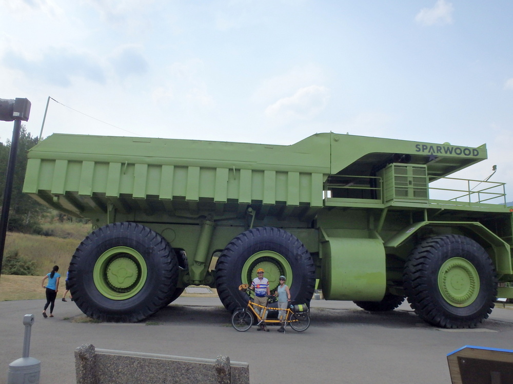 GDMBR: Dennis and Terry Struck and the Bee, with the World's Largest Truck in Sparwood, Canada.